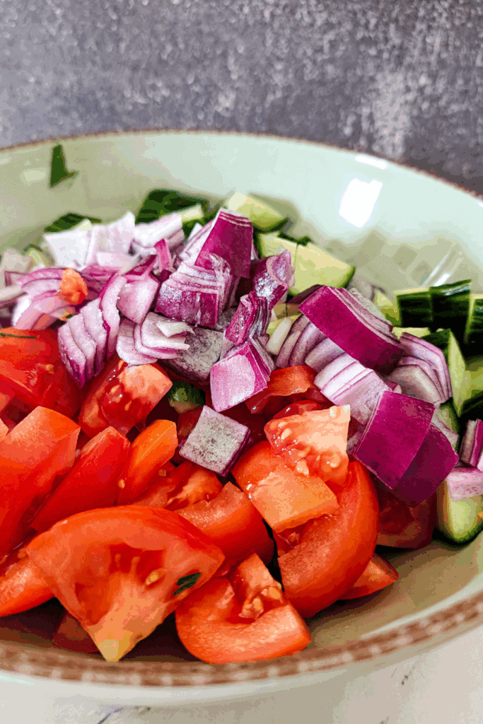 adding red onion to the salad
