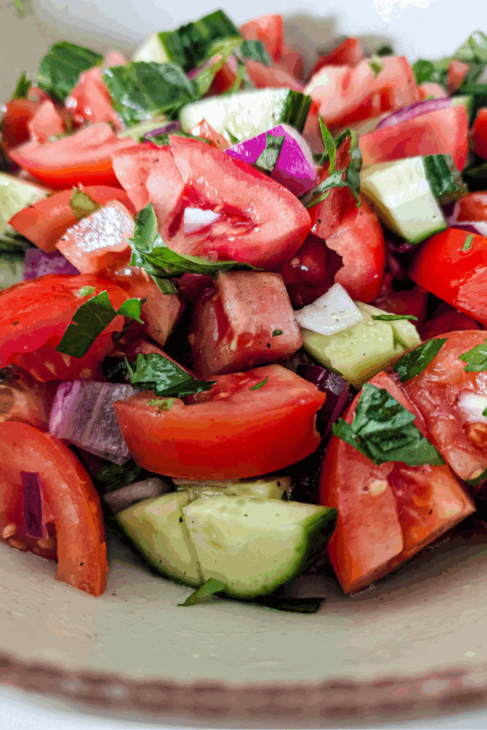 dressed salad with fresh basil tomato cucumber