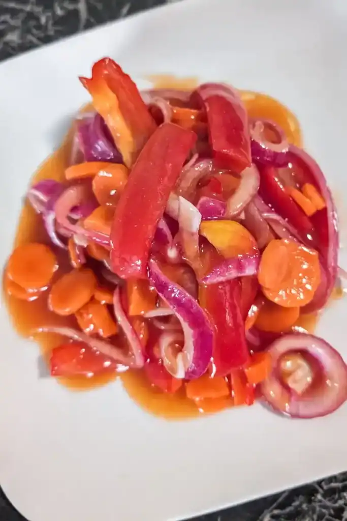the marinated copper penny salad on a white plate zoomed out