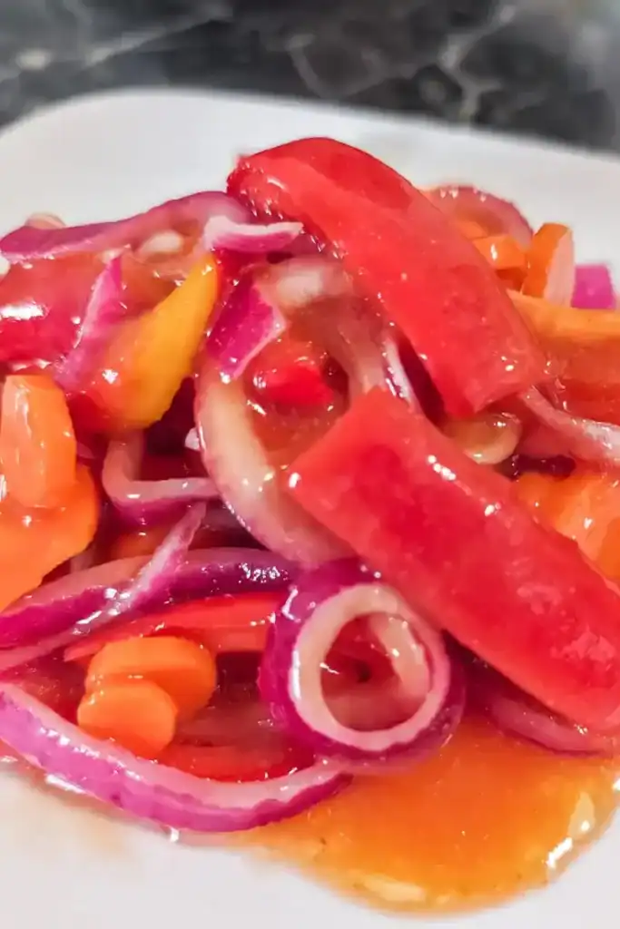 the marinated copper penny salad on a white plate zoomed in
