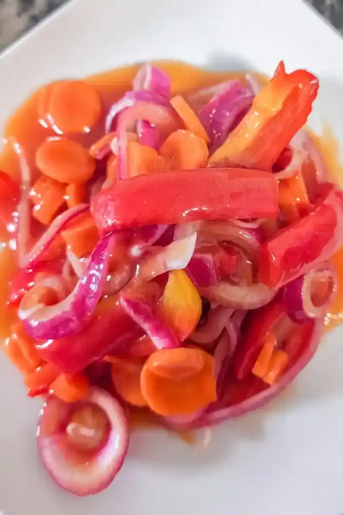 the marinated copper penny salad on a white plate alternate angle