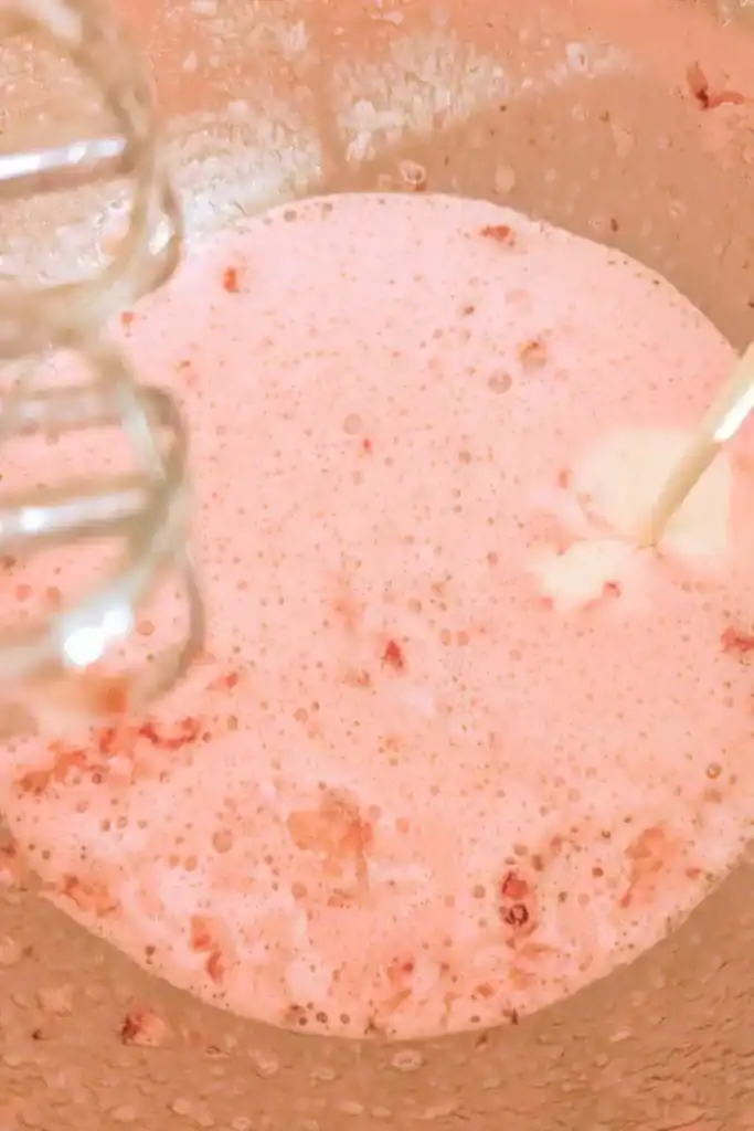 adding heavy cream to strawberry mixture
