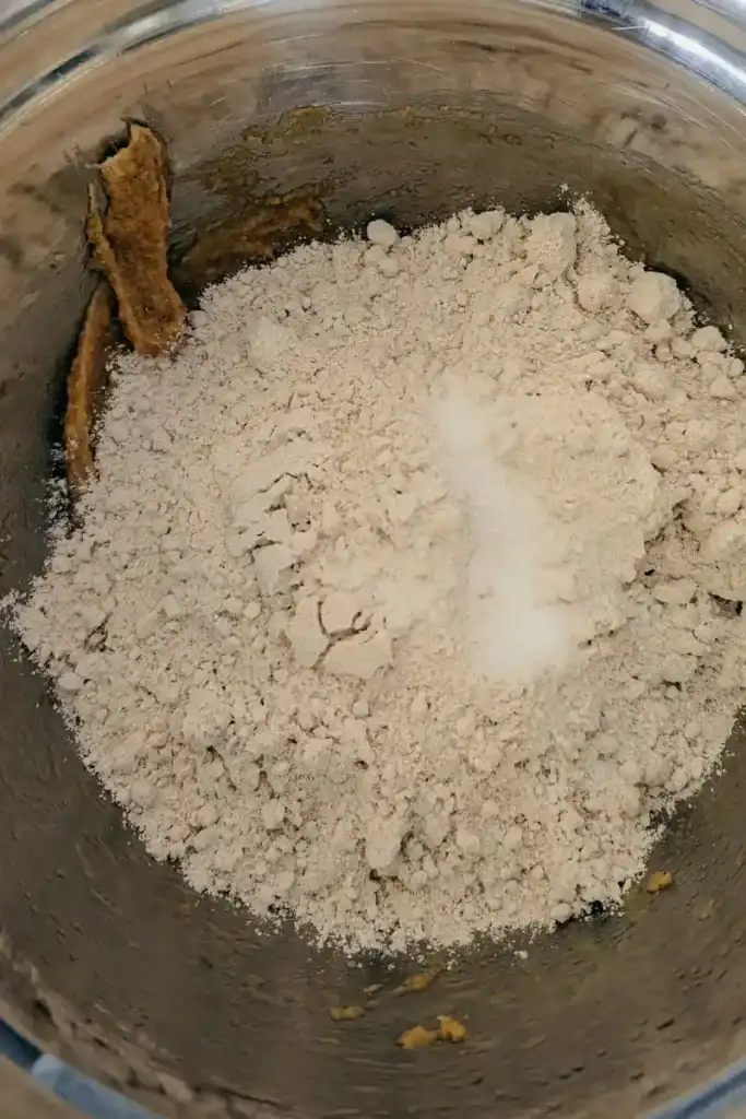 adding oat flour and dry ingredients to cookie dough