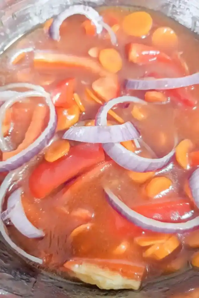 stir the salad ingredients together in the marinade