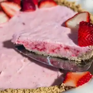 recipe card image of sliced strawberry frozen no bake pie