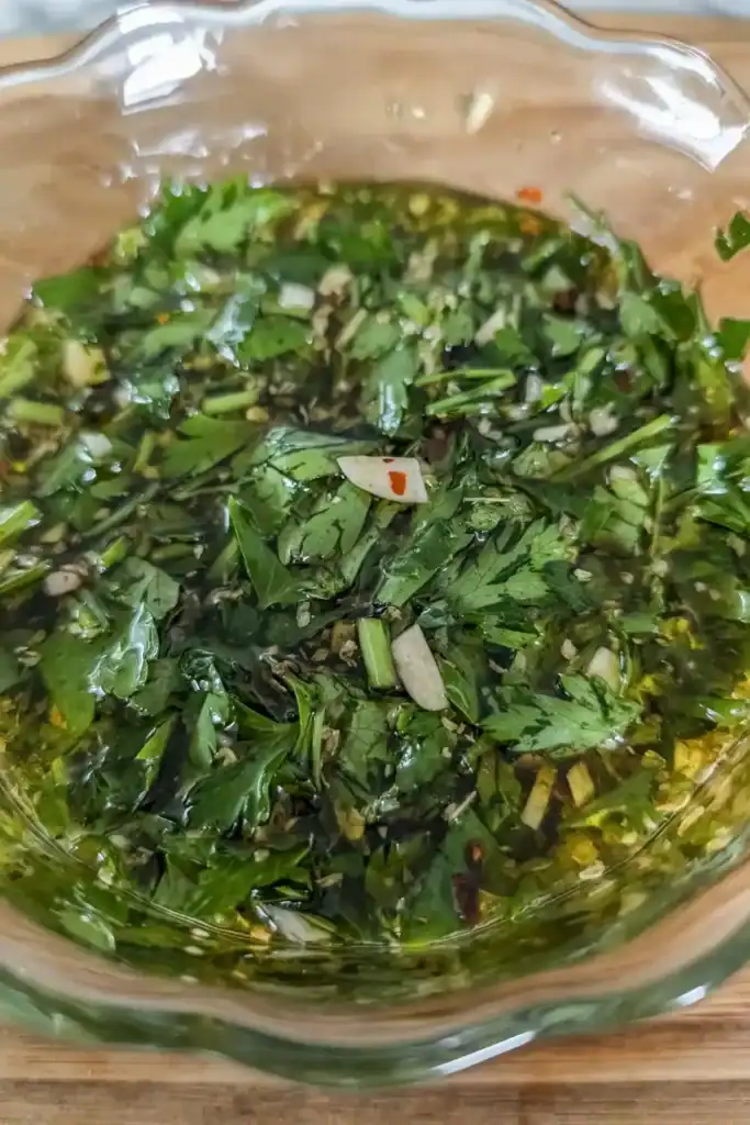mixing the finished chimichurri sauce