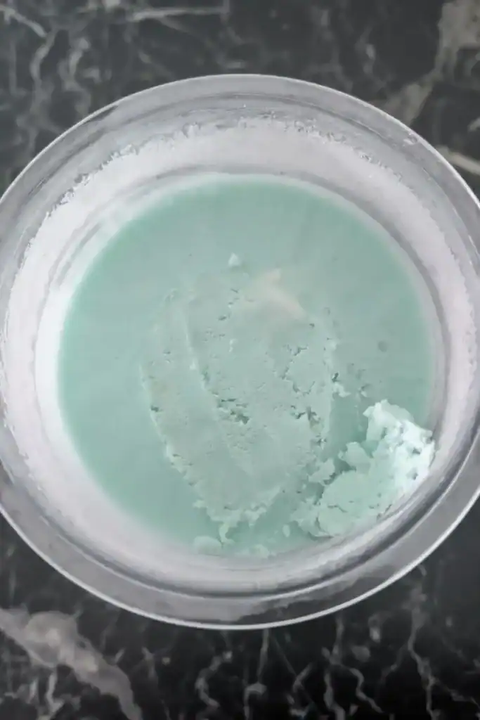 scraping the ice cream bump off frozen contents of pint