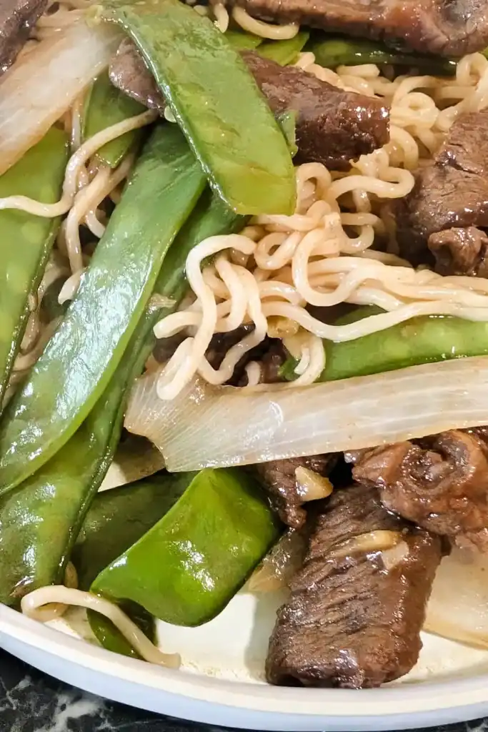 close up of the ginger beef and snow pea noodle dish