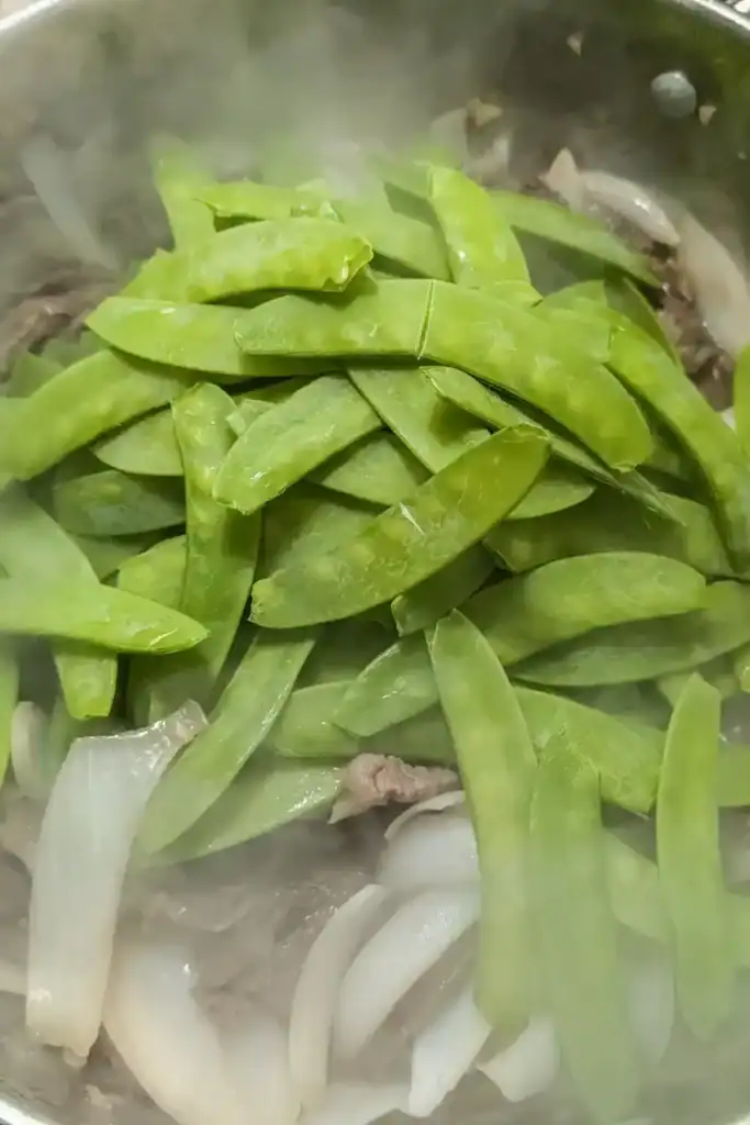 adding snow peas to dish
