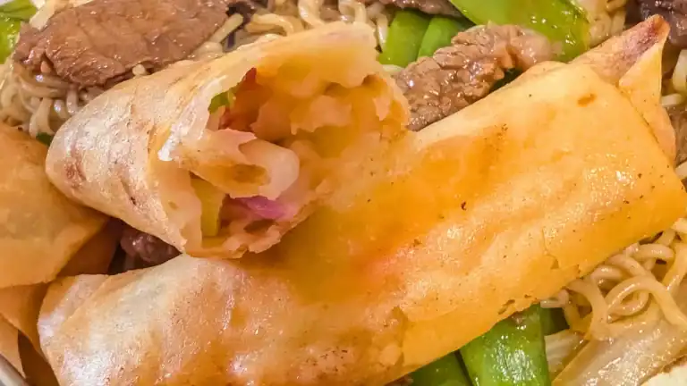 featured image of a whole spring roll with one broken open resting on it