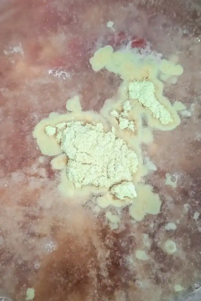 adding ginger powder to bbq sauce in bowl