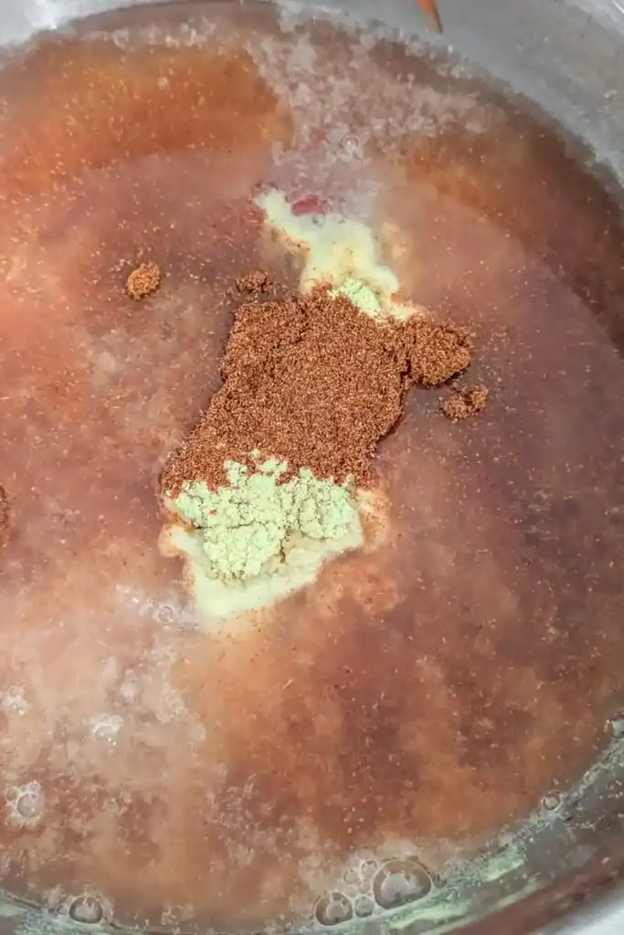 adding chipotle pepper to bbq sauce mixture in bowl