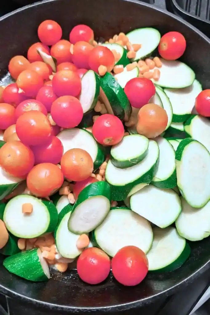 fresh corn tomato zucchini in cast iron skillet