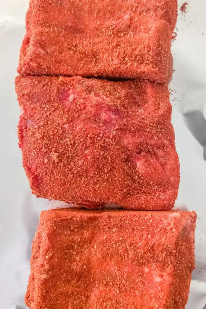 laying dry rubbed rib sections onto aluminum foil