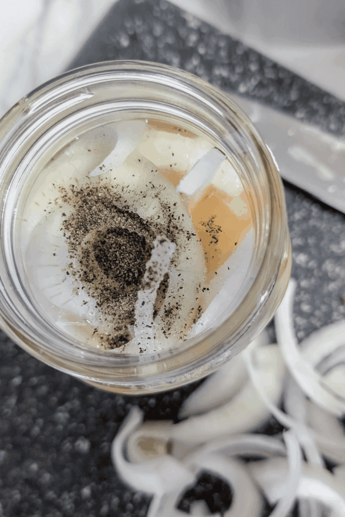 adding black pepper before shaking with lid