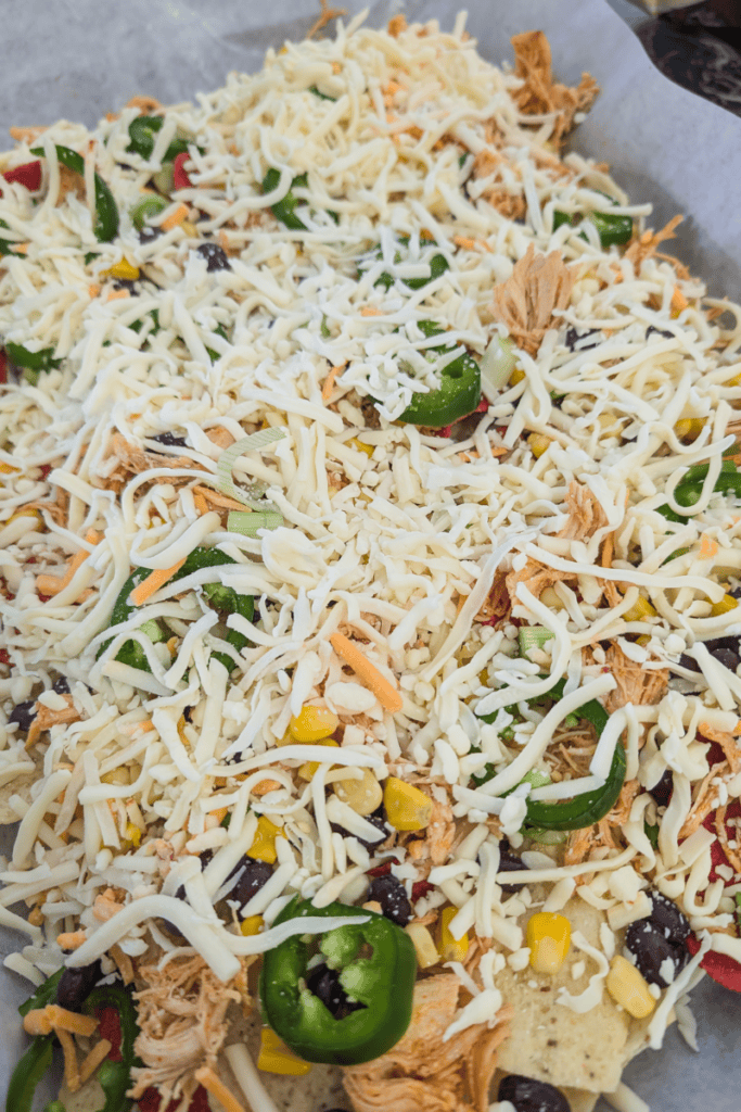 Delicious buffalo chicken nachos topped with cheese, jalapenos, and shredded chicken.