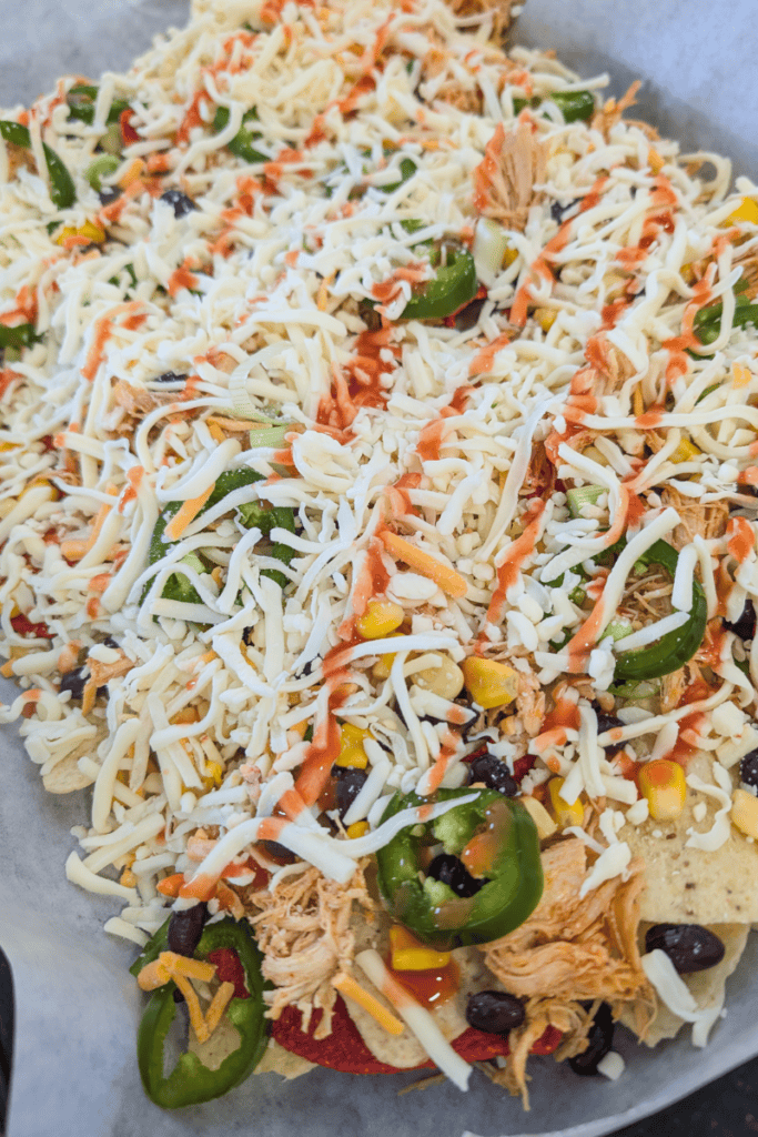 Delicious buffalo chicken nachos topped with cheese, jalapenos, and shredded chicken.