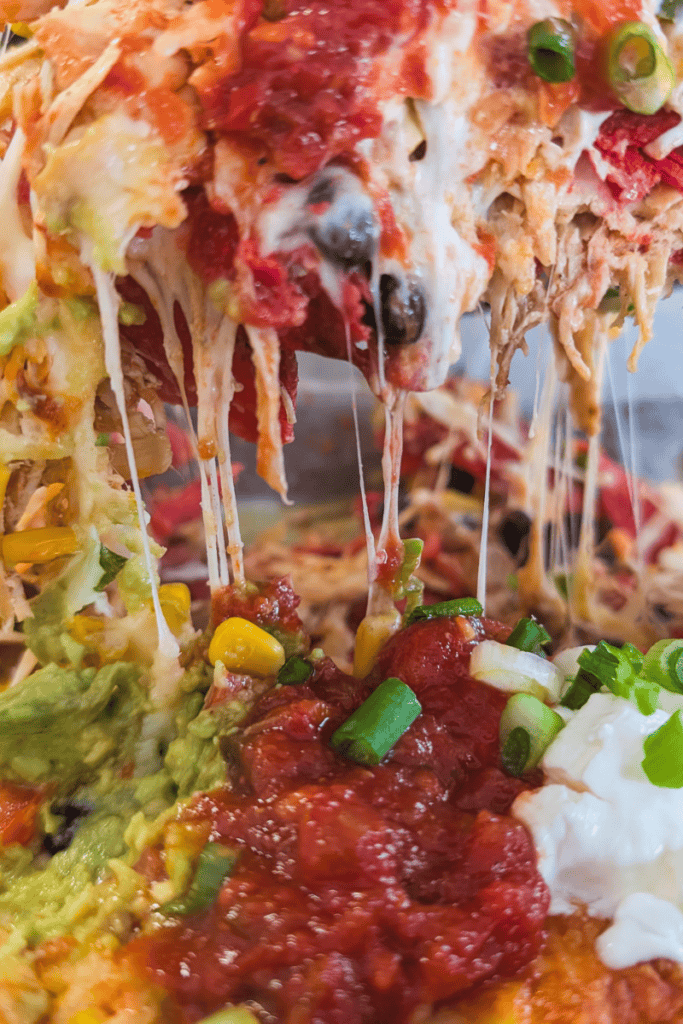 Delicious buffalo chicken nachos with melted cheese and toppings.