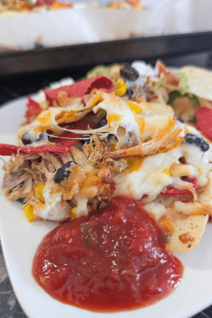 Delicious buffalo chicken nachos with cheese and toppings.