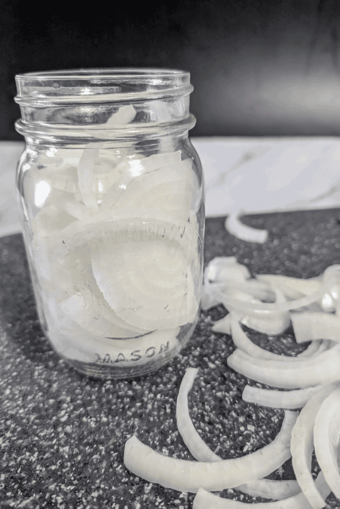 packing mason jar with onion