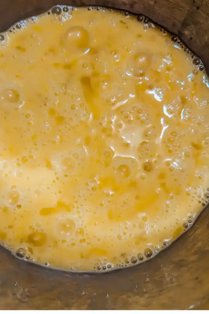 beaten eggs in frying pan