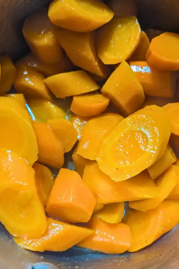 adding melted butter to honey ginger carrots