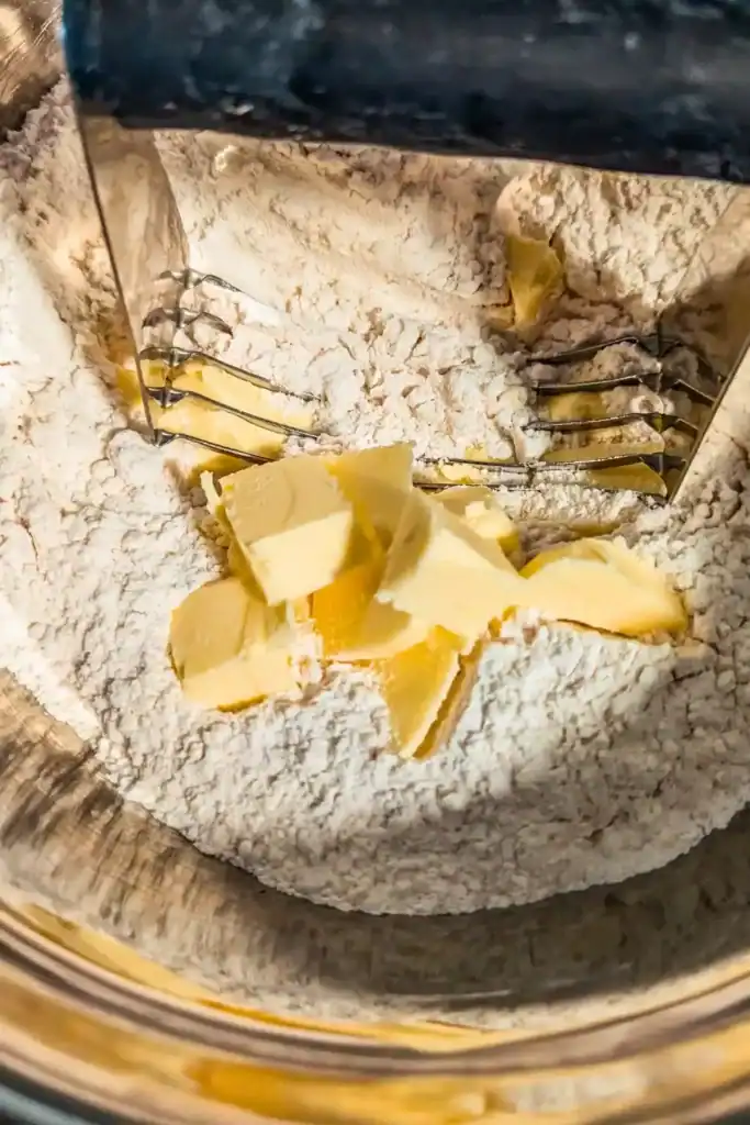 using pastry cutter to cut butter into dry ingredients
