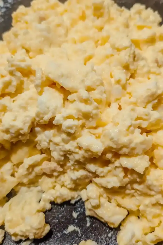 the finished scrambled eggs in frying pan