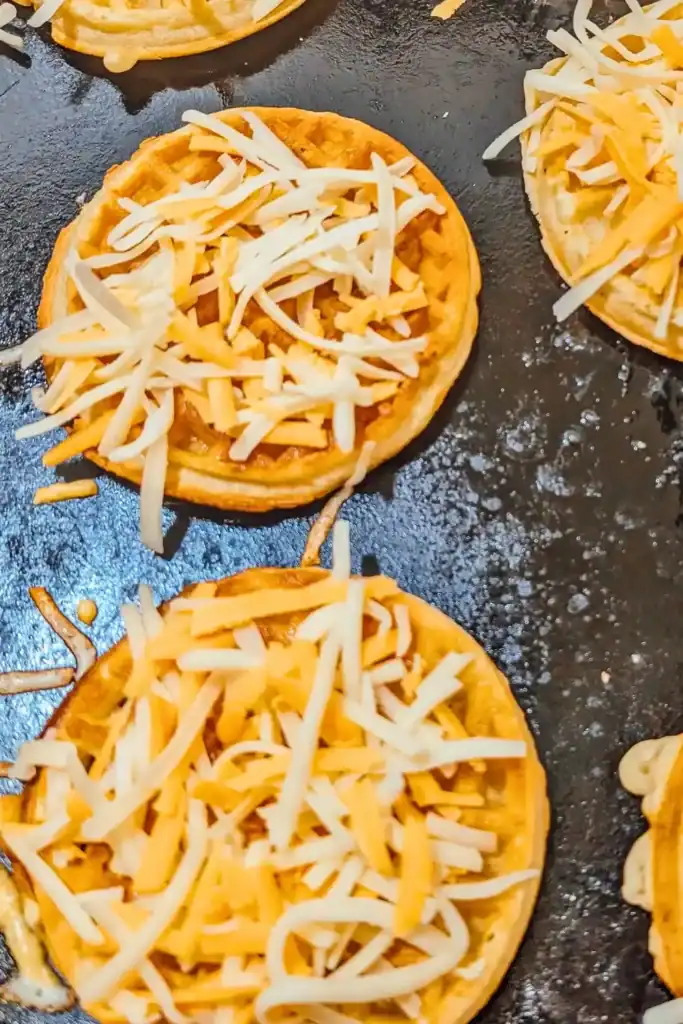 adding cheese to waffle sandwiches