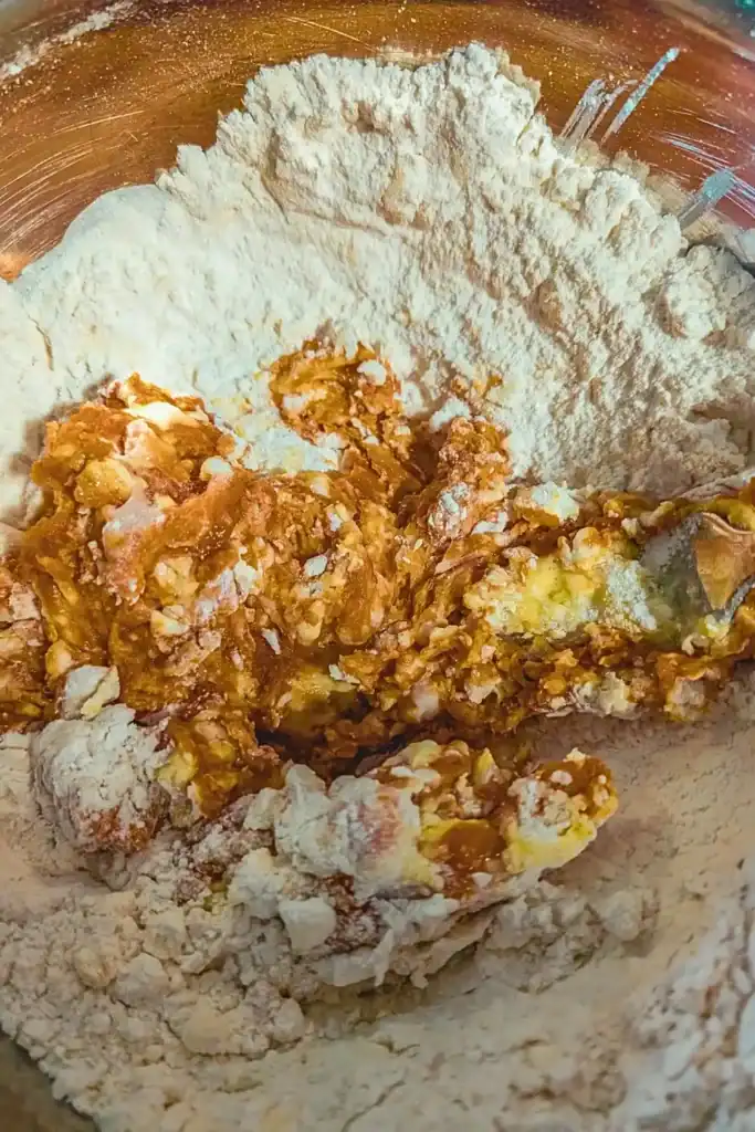 adding the pumpkin spice and pumpkin puree to the scone batter