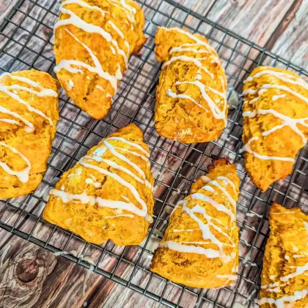 baked pumpkin spice scones with icing on wire rack