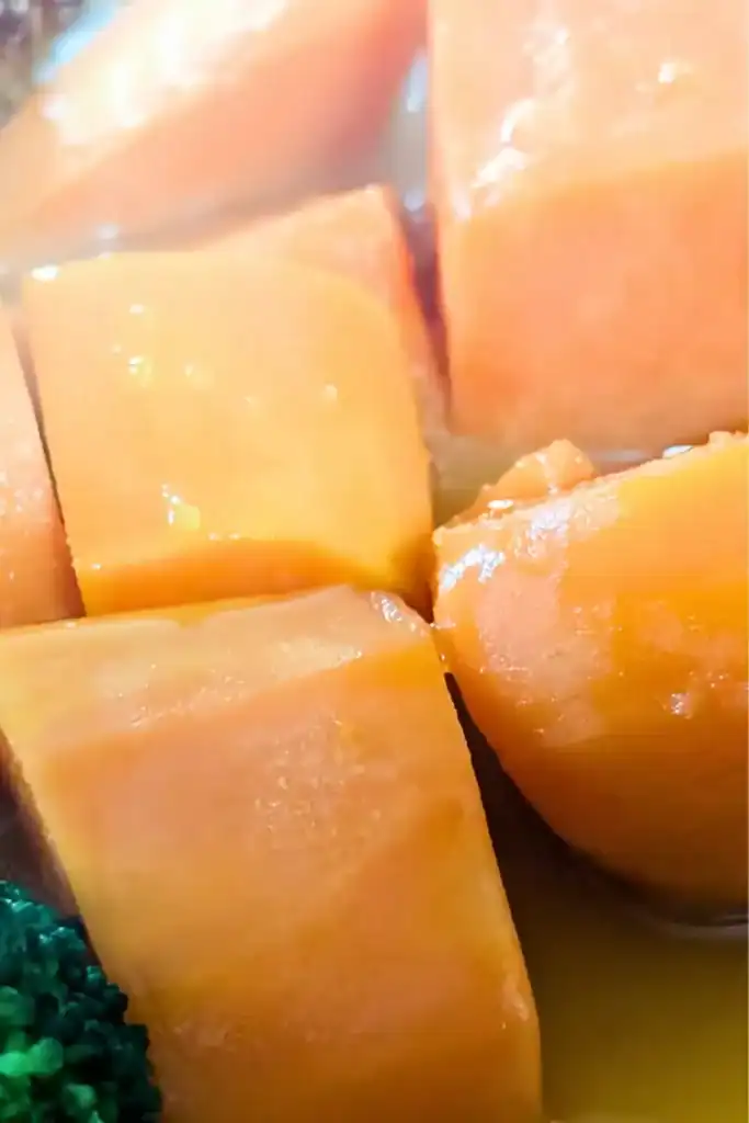 close up cooked sweet potato a bit of broccoli lower left of frame