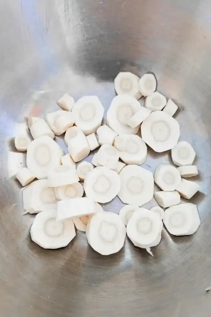 sliced parsnips in stainless steel bowl