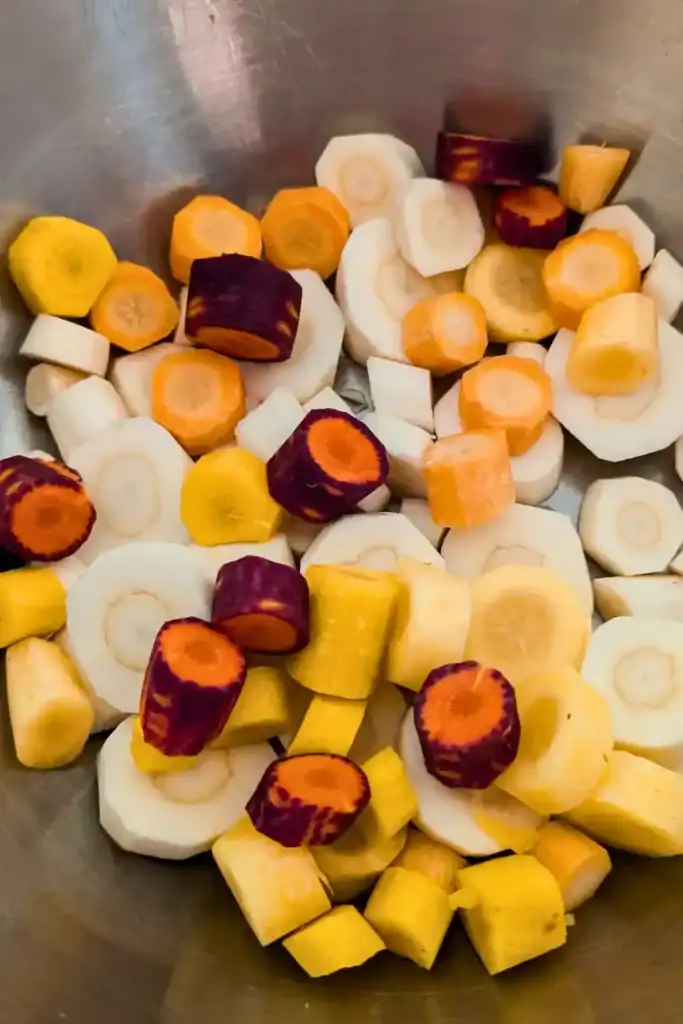 heirloom carrots purple and yellow with parsnips in bowl