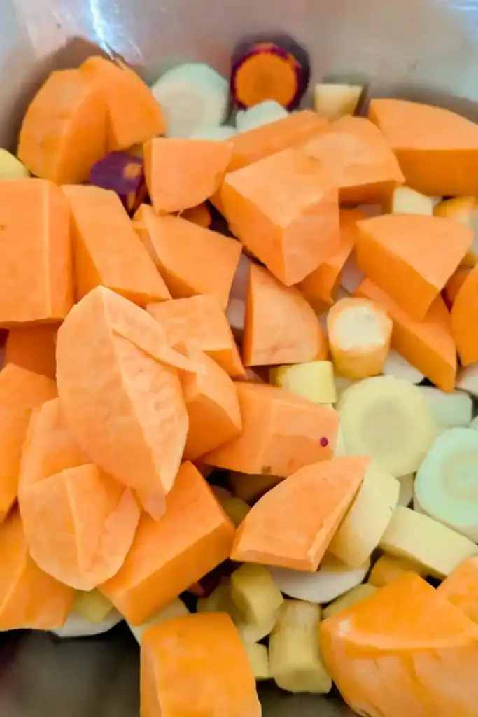 adding sweet potato to other veg in bowl