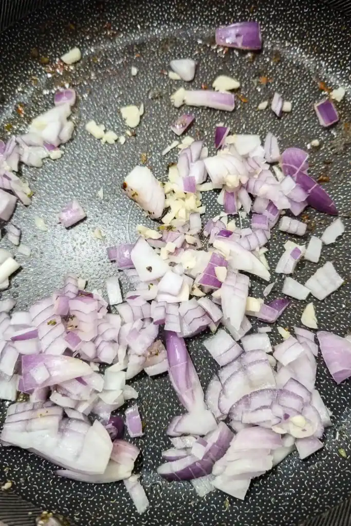 sauting onion and garlic in meat drippings in frying pan