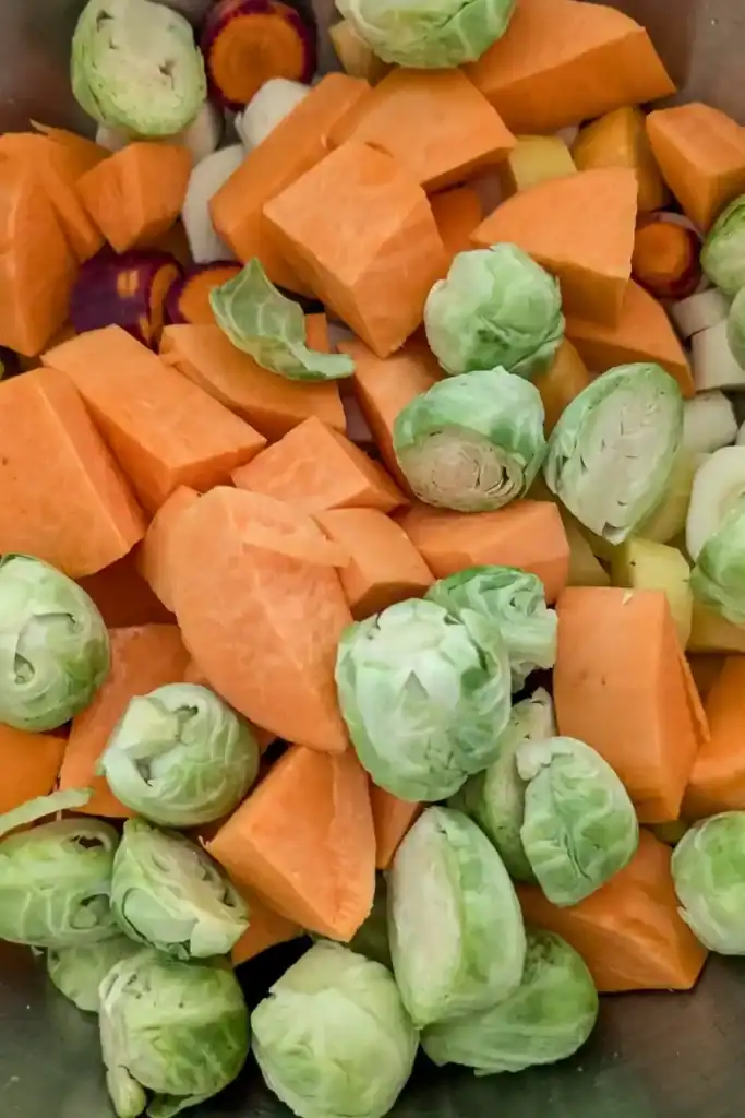 adding brussels sprouts to veg in bowl