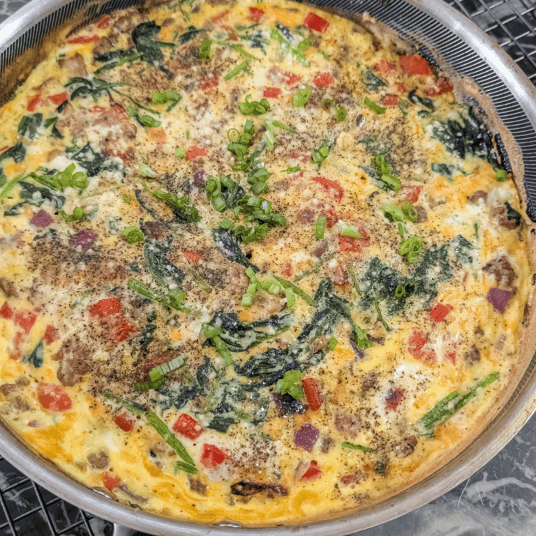 Delicious sausage and spinach frittata with fresh herbs and vegetables.