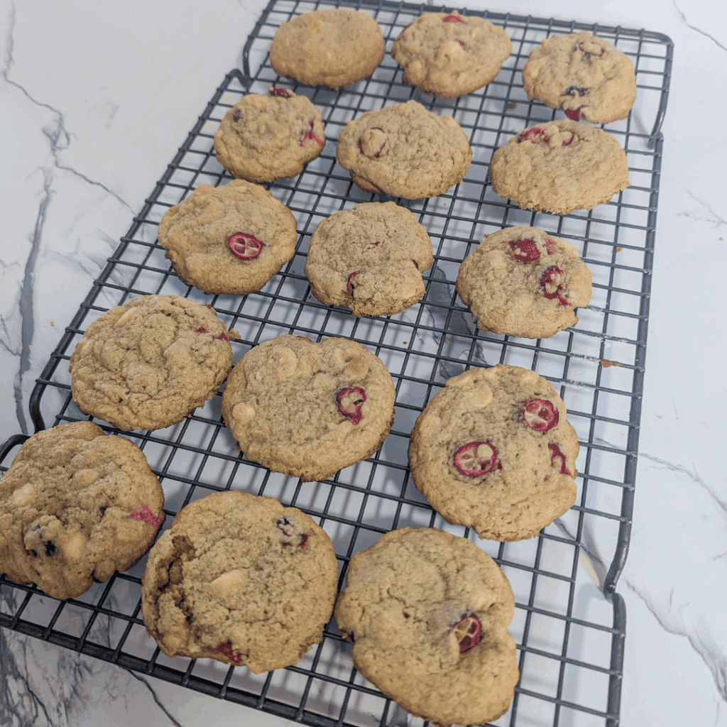 Buttery cherry oatmeal cookies cooling on a wire rack.