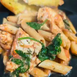 Tuscan inspired chicken penne pasta with rose sauce and baby spinach