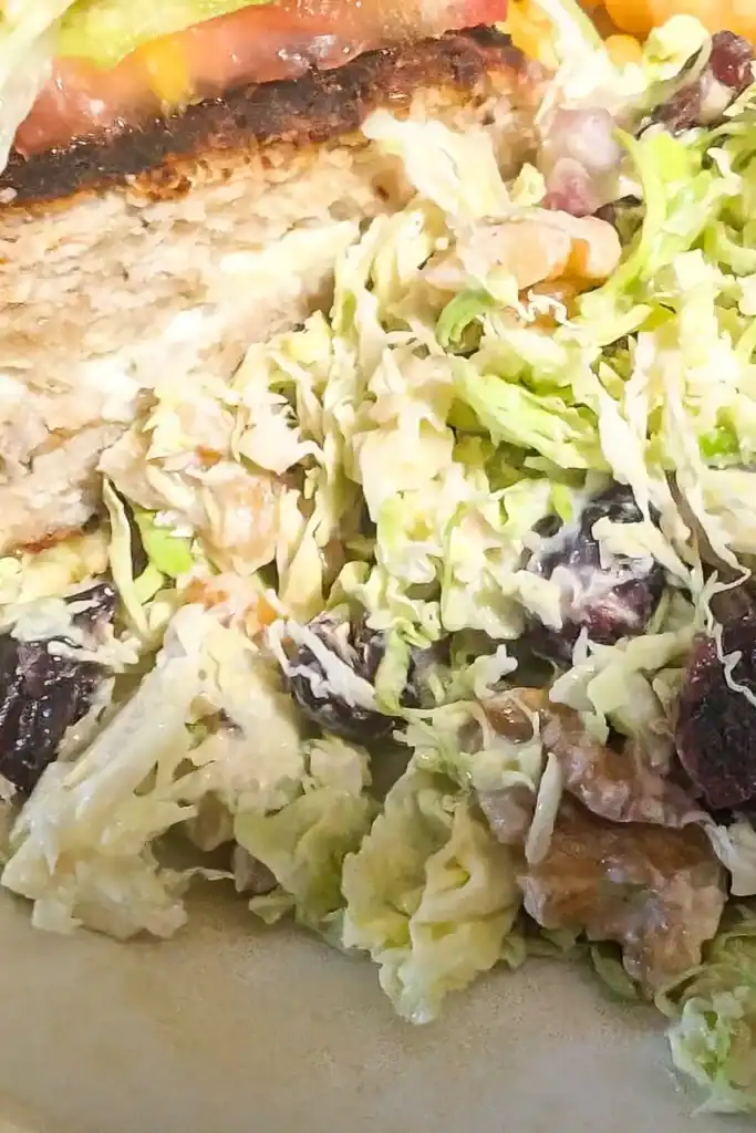 brussels sprouts salad with turkey burger on plate