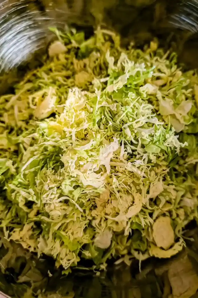 shaved brussels sprouts in stainless steel bowl