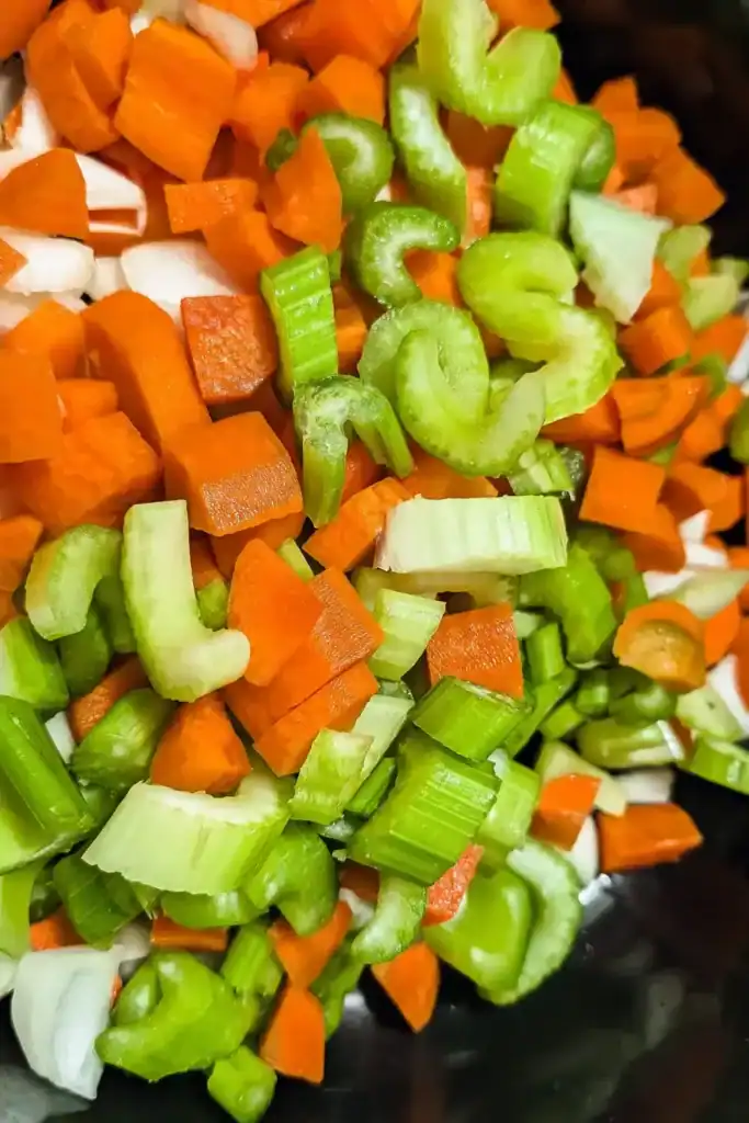 cut up carrots onion celery in olive oil in Dutch oven