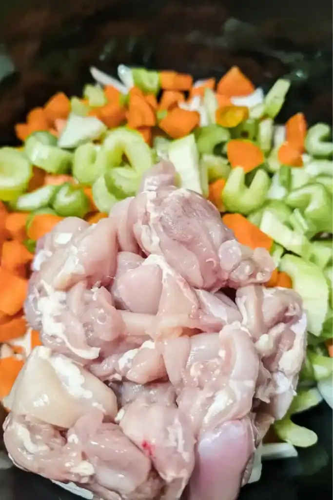 Adding cut up boneless skinless chicken thighs to the mirepoix