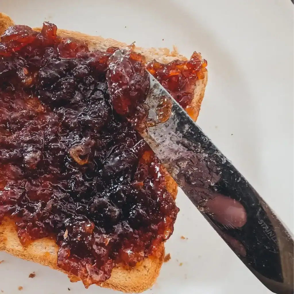 spreading apple butter on toast