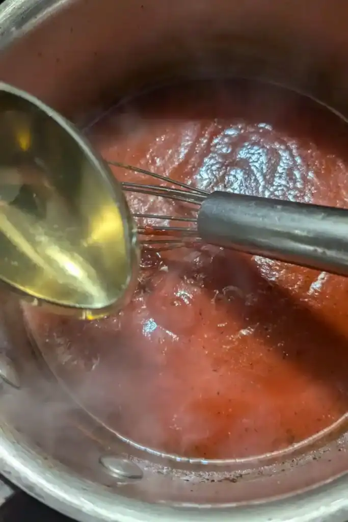 whisking in the honey to the harissa sauce
