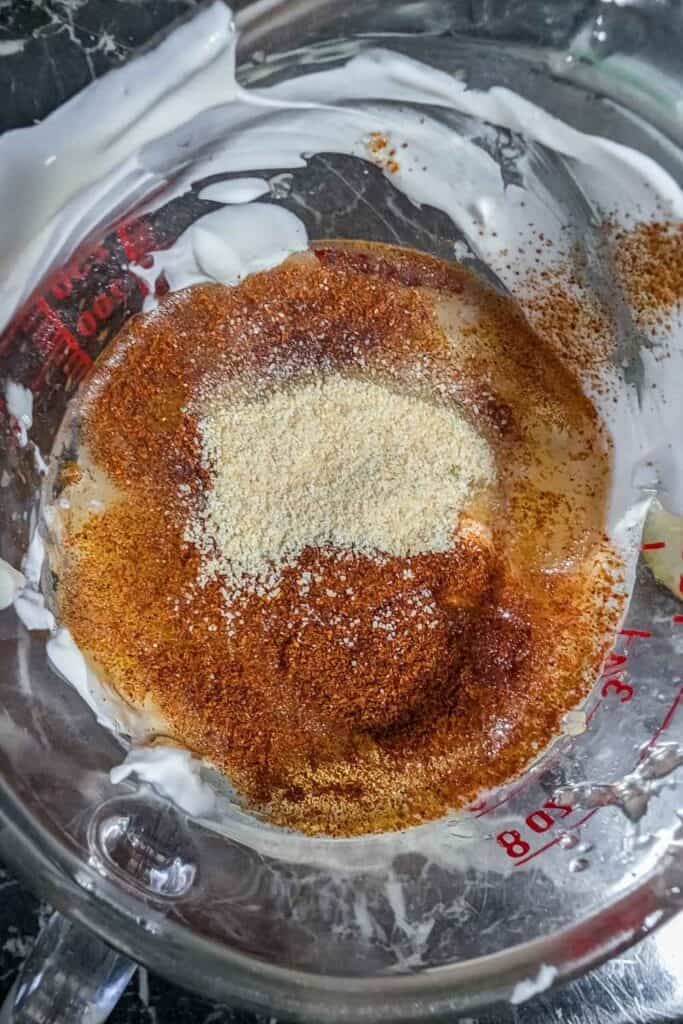 adding spices to making the dressing in cup