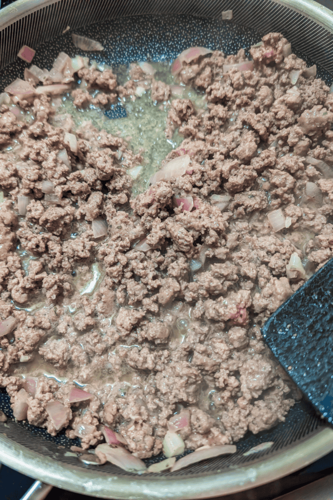 browned ground beef in frying pan