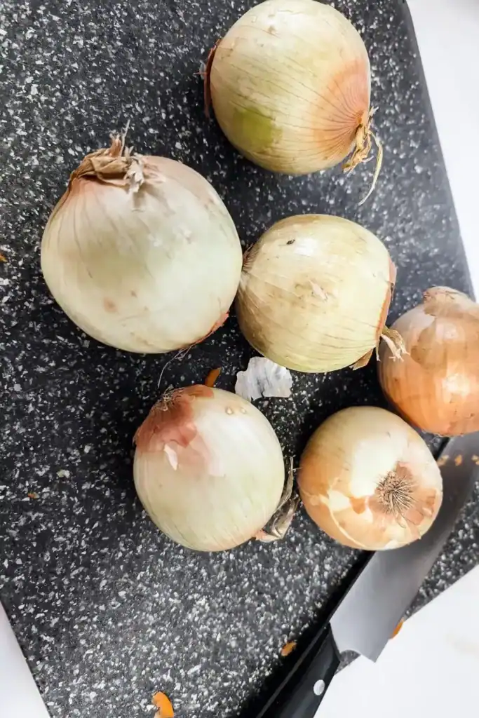 onions on cutting board with knife