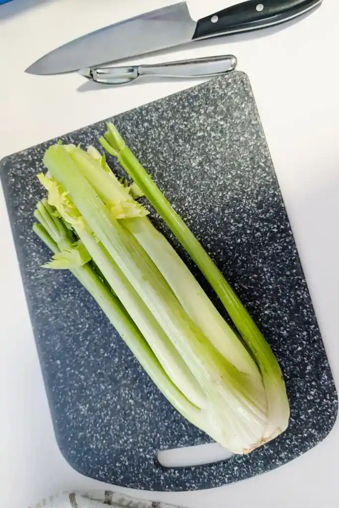 celery on cutting board with knife beside